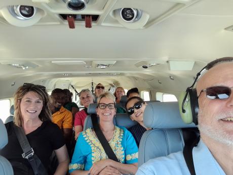 The medical mission team with MAF's John Feil on the flight back to Conakry.